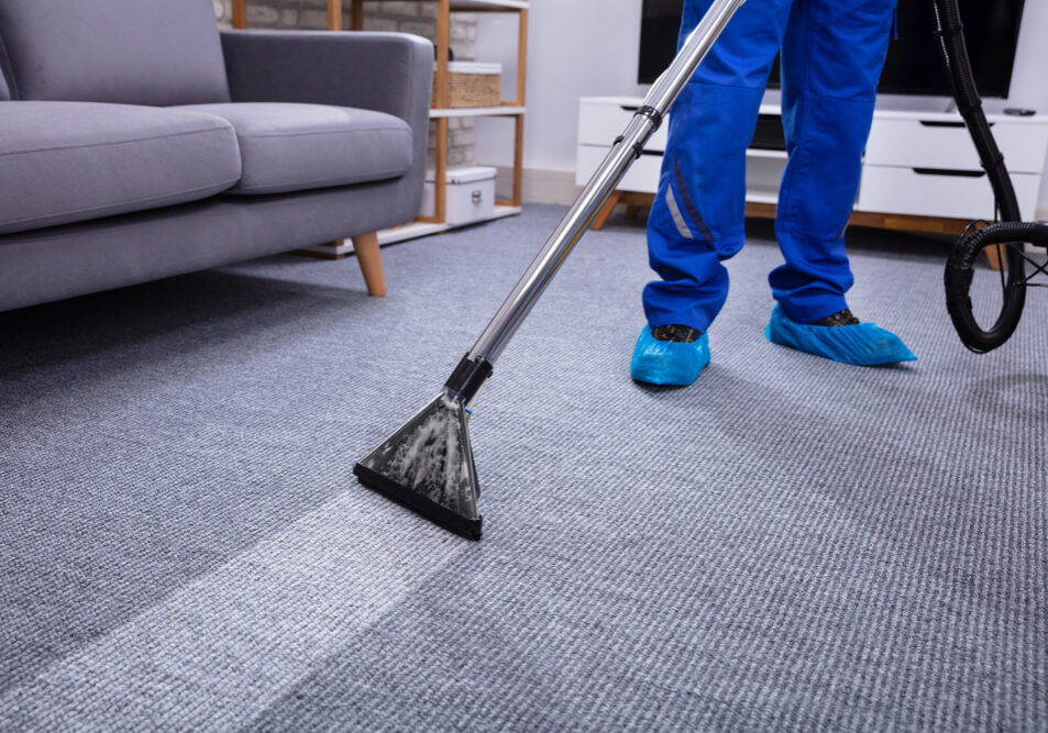 Low,Section,Of,A,Male,Janitor,Cleaning,Carpet,With,Vacuum